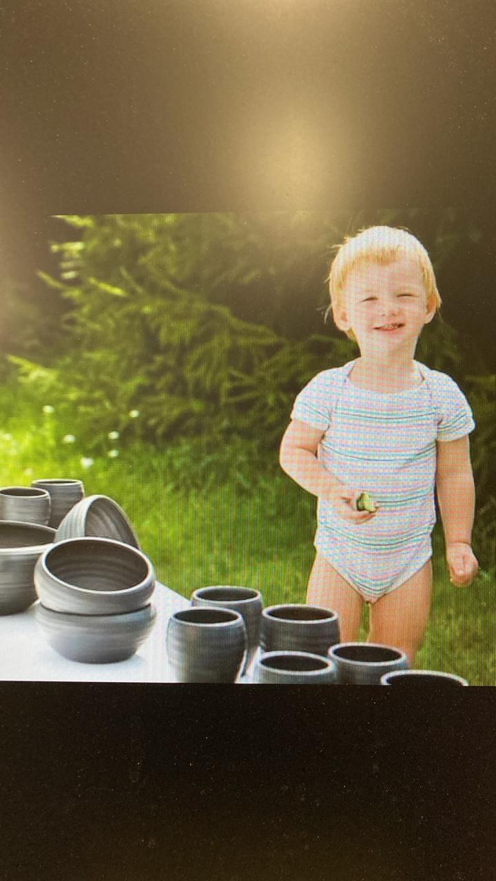 Matiass as a boy, working clay at the family table